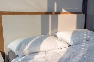 a bed with two pillows on top of it at 49floor with Workspace Pool and Gym with MRT 200m in Bangkok