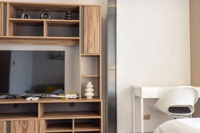 a bedroom with a bed and a desk with a television at 49floor with Workspace Pool and Gym with MRT 200m in Bangkok