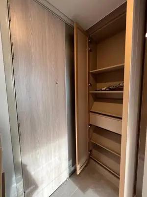a walk in closet with wooden doors and shelves at 47fl Skyview with Balcony Pool Gym 200m from MRT in Bangkok