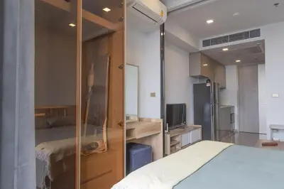 a bedroom with a bed and a mirror at 47fl Skyview with Balcony Pool Gym 200m from MRT in Bangkok