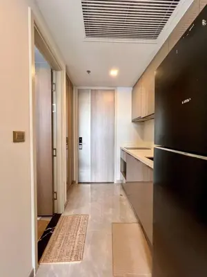 a kitchen with a black refrigerator and a hallway at In Unit Workspace Gym and Infinity Pool MRT 200m in Bangkok