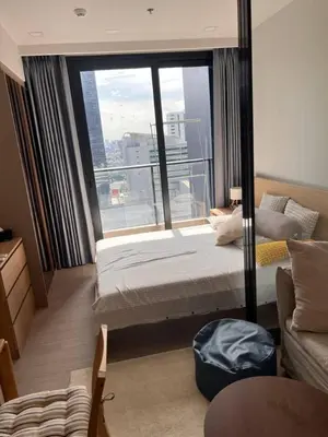 a hotel room with a bed and a large window at In Unit Workspace Gym and Infinity Pool MRT 200m in Bangkok