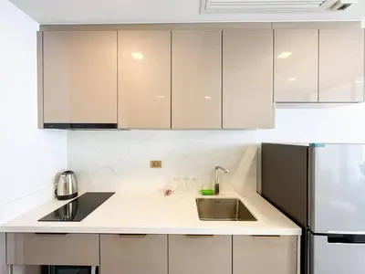 a kitchen with a sink and a refrigerator at High Skyview Studio with Desk Pool Gym MRT 200m in Ban Na Song
