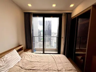 a bedroom with a bed and a large window at Free Parking with Balcony Pool and Gym MRT 200m in Ban Na Song