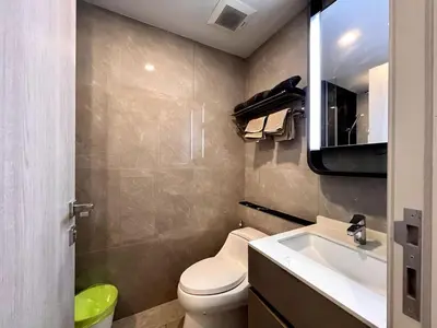 a bathroom with a toilet and a sink and a mirror at Free Parking with Balcony Pool and Gym MRT 200m in Ban Na Song