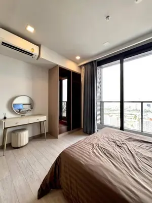 a bedroom with a large bed and a desk and window at 40th Fl Skyview with Standing Desk Pool and Gym in Ban Na Song