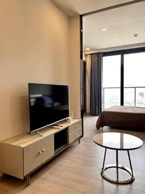 a hotel room with a television and a bed at 40th Fl Skyview with Standing Desk Pool and Gym in Ban Na Song