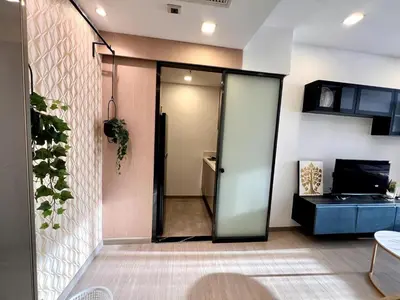 a room with a door leading to a kitchen at King Bed with Living Room Pool and Gym MRT 200m in Ban Na Song