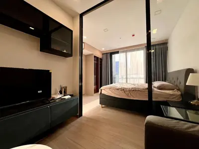 a bedroom with a bed and a large mirror at King Bed with Living Room Pool and Gym MRT 200m in Ban Na Song