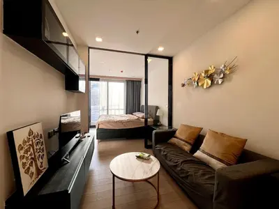 a living room with a couch and a bed at King Bed with Living Room Pool and Gym MRT 200m in Ban Na Song