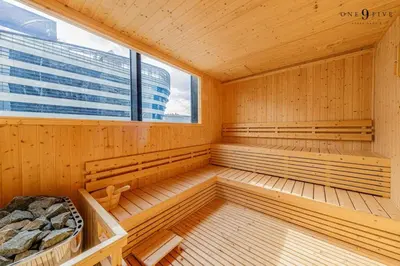 a sauna with wooden benches and a large window at 53Fl Skyview with King Bed Pool and Gym MRT200m in Ban Na Song