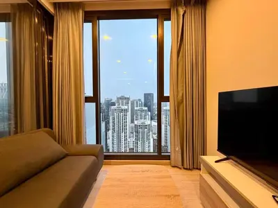 a living room with a couch and a large window at Peak Luxury Living with King Bed Golf Pool and Gym in Ban Na Song