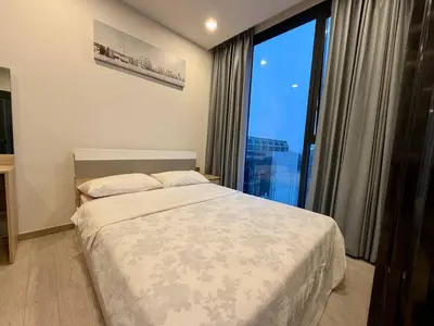 a bedroom with a bed and a large window at Peak Luxury Living with King Bed Golf Pool and Gym in Ban Na Song