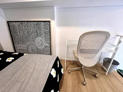 a bedroom with a bed and a desk and a chair at High Floor Loft with Pool and Gym in Ban Na Song