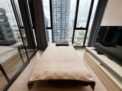 a large room with large windows in a building at Spacious Apt with King Bed Pool and Gym MRT200m in Bangkok