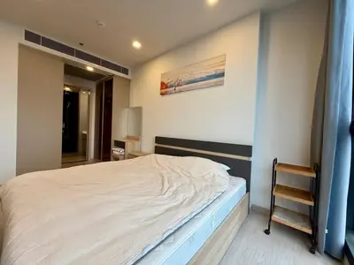 a small bedroom with a bed and a mirror at Spacious Apt with King Bed Pool and Gym MRT200m in Bangkok