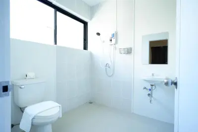 a white bathroom with a toilet and a shower at XX Snap inn Sukhumvit 1 สแนป สุขุมวิท ซอย 1 in Makkasan
