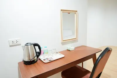 a table with a coffee maker on top of it at XX สแนปอิน สุขุมวิท 1 - Snap Inn Sukhumvit 1 in Makkasan
