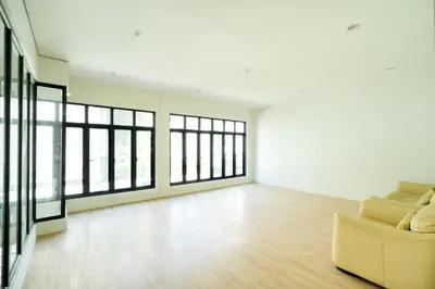 an empty room with a couch and windows at xx Snap Inn Sukhumvit 1 - สแนป อินน์ สุขุมวิท 1 in Makkasan
