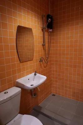 a bathroom with a toilet and a sink and a shower at Wat We See Bangkok Hostel in Bangkok