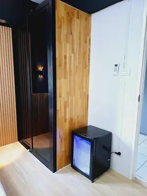 a television sitting on the floor in a room at Irich Theparak S207- Bts-Chang Erawan 2kms in Ban Khlong Hua Sakae