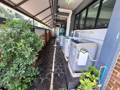 a greenhouse with a row of plants and machines at Irich Theparak S207- Bts-Chang Erawan 2kms in Ban Khlong Hua Sakae