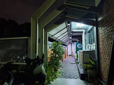 a hallway of a building with plants on it at night at Irich Theparak S207- Bts-Chang Erawan 2kms in Ban Khlong Hua Sakae