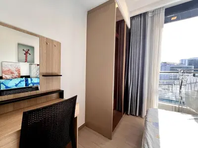 a bedroom with a bed and a large window at Free Parking with Balcony Pool and Gym MRT 200m in Ban Na Song