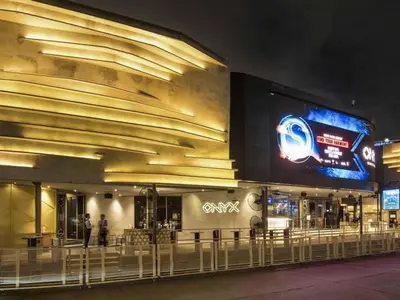 a building with a large sign in front of it at night at Free Parking with Balcony Pool and Gym MRT 200m in Ban Na Song