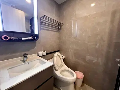 a bathroom with a toilet and a sink at Free Parking with Balcony Pool and Gym MRT 200m in Ban Na Song