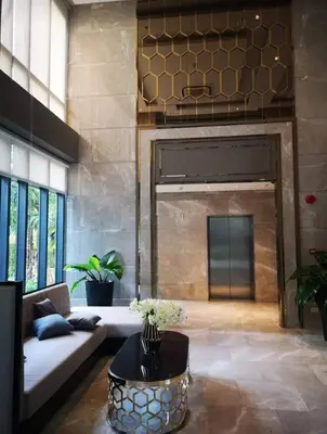 a living room with a couch and a table at Mayfair Bangkok in Bangkok