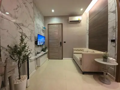 a bathroom with a tub and a sink and a tv at Mayfair Bangkok in Bangkok