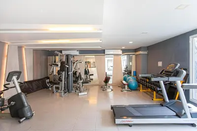 a gym with several treadmills and exercise equipment at Dazzle Residence ByPinny in Bangkok