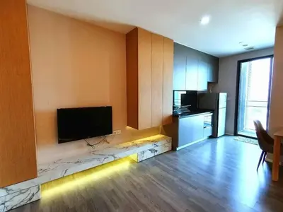 a living room with a flat screen tv on a wall at The room, luxury condo 21fl 1 Bedroom ,near bts in Bangkok