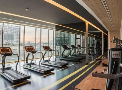 a gym with a row of treadmills at The room, luxury condo 21fl 1 Bedroom ,near bts in Bangkok