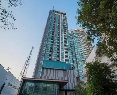 a tall building with glass windows in a city at The room, luxury condo 21fl 1 Bedroom ,near bts in Bangkok