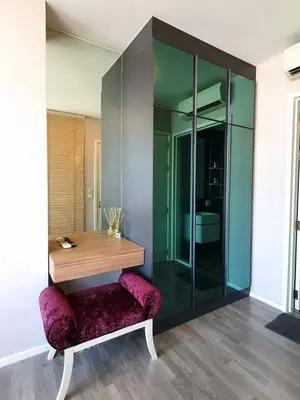 a room with a wooden table and a purple bench at The room, luxury condo 21fl 1 Bedroom ,near bts in Bangkok