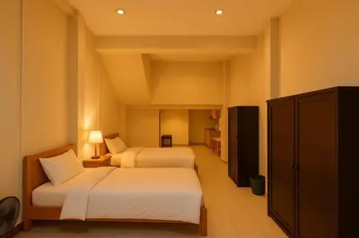 a hotel room with two beds and a cabinet at Niche Space Sripraya- Samyan in Bangkok