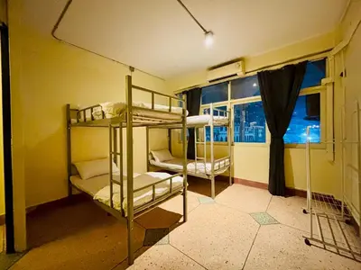 two bunk beds in a room with a window at Sukhum Charoen Krung Tak-Sin bridge guest house in Bangkok