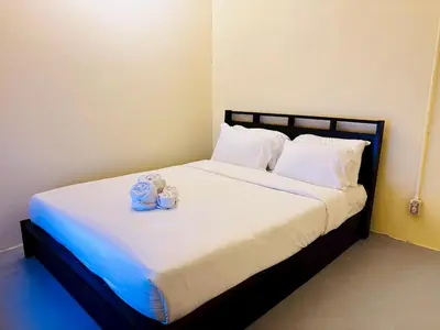 a bedroom with a bed with two teddy bears on it at Sukhum Charoen Krung Tak-Sin bridge guest house in Bangkok