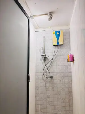 a shower with a shower head in a bathroom at Sukhum Charoen Krung Tak-Sin bridge guest house in Bangkok