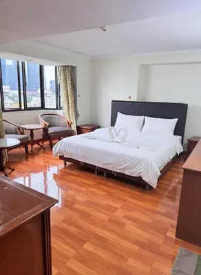 a bedroom with a large bed and a wooden floor at Beautiful 1 bedroom Appartment in the Heart of Bangkok in Bangkok