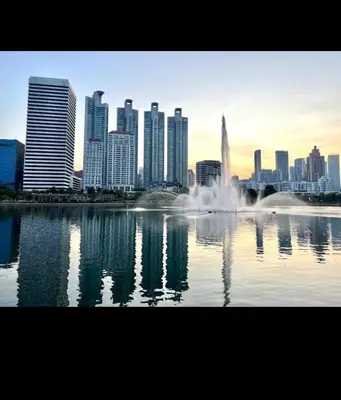 a city skyline with a fountain in a body of water at Beautiful 1 bedroom Appartment in the Heart of Bangkok in Bangkok