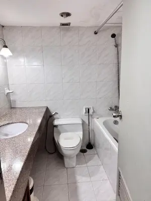 a bathroom with a toilet and a sink and a tub at Beautiful 1 bedroom Appartment in the Heart of Bangkok in Bangkok