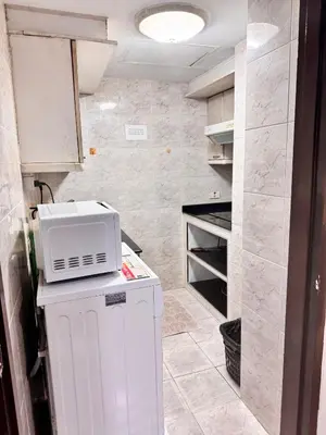 a kitchen with a microwave on top of a refrigerator at Beautiful 1 bedroom Appartment in the Heart of Bangkok in Bangkok