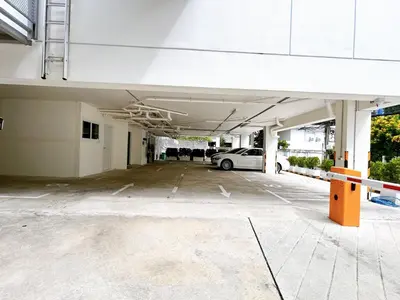 an empty parking lot with a car parked in it at Komfort Duplex BTS Ratchayothin in Bangkok