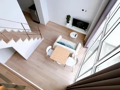 an overhead view of a living room with a couch and a table at Komfort Duplex BTS Ratchayothin in Bangkok