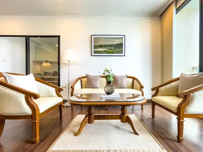 a living room with two chairs and a coffee table at Near BTS l Large 85 sqm l Rooftop Pool l Sontana in Bangkok