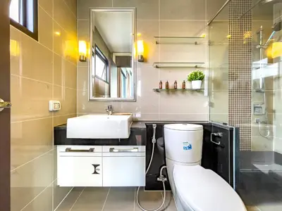 a bathroom with a toilet and a sink at Near BTS l Large 85 sqm l Rooftop Pool l Sontana in Bangkok