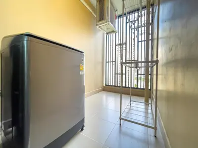 a television sitting in a room with a window at Near BTS l Large 85 sqm l Rooftop Pool l Sontana in Bangkok